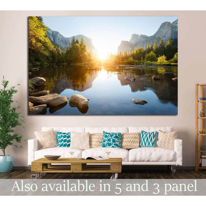Granite Cliffs and River Reflection Wall Decor - Yosemite Landscape ArtworkThis canvas print offers a stunning portrayal of Yosemite Valley at sunrise, with the sun's first rays illuminating the granite cliffs and casting reflections on the calm waters of