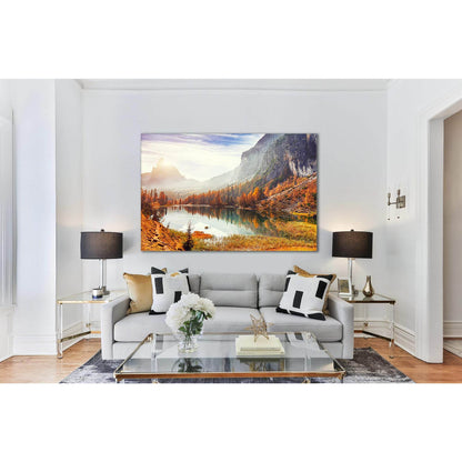 Federa Lake Reflections: Artwork for Cozy InteriorsThis canvas print showcases the warm, golden tones of autumn at Federa Lake, flanked by rugged cliffs and a tranquil reflection. Ideal as an art print for creating a focal point in any room, this piece of