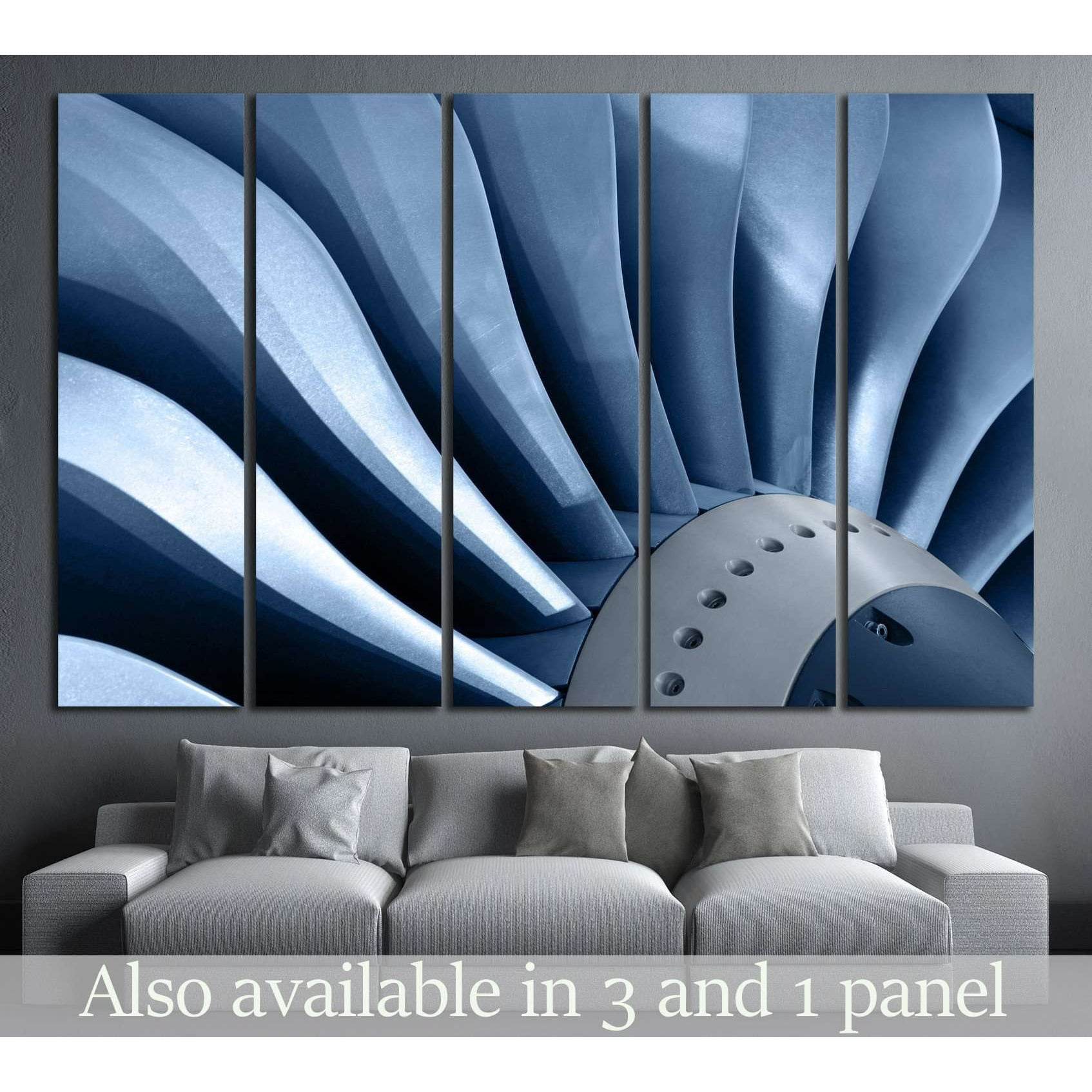Blue metal turbine blades canvas print hung above a sofa in a modern industrial living room