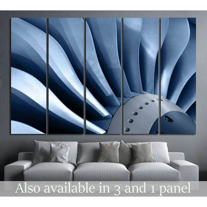 Blue metal turbine blades canvas print hung above a sofa in a modern industrial living room
