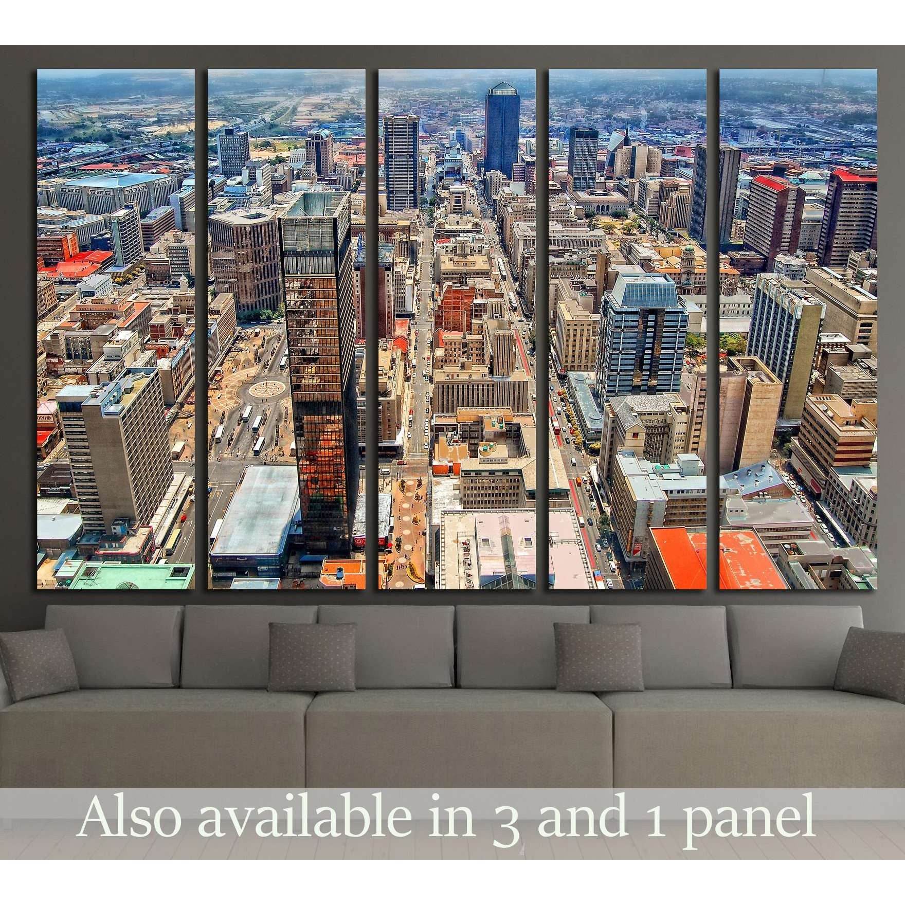 Johannesburg skyline canvas print with aerial downtown towers, displayed above a sofa in a modern living room