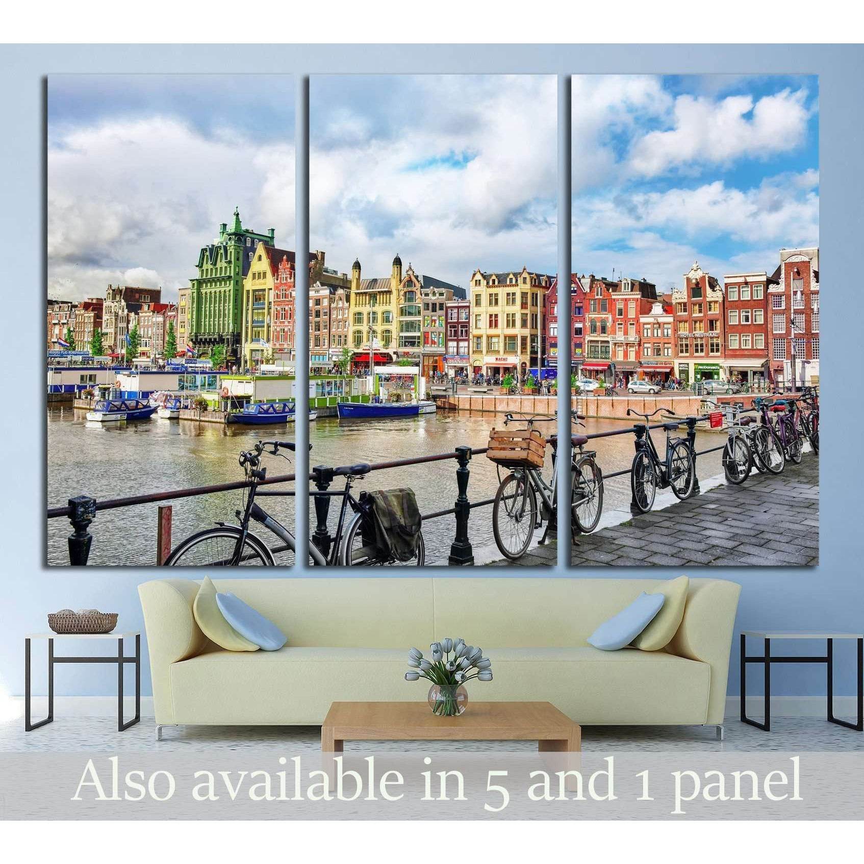 Amsterdam canal houses triptych canvas print with bicycles along the waterfront above a sofa