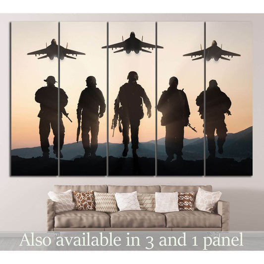 Army soldiers silhouette canvas print with fighter jets at sunset displayed above a sofa in a neutral living room