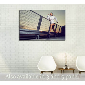 Woman running at sunset on an urban rooftop canvas print displayed above chairs in a modern room