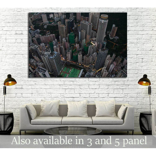 Hong Kong skyline aerial canvas print hung above a sofa in a modern living room