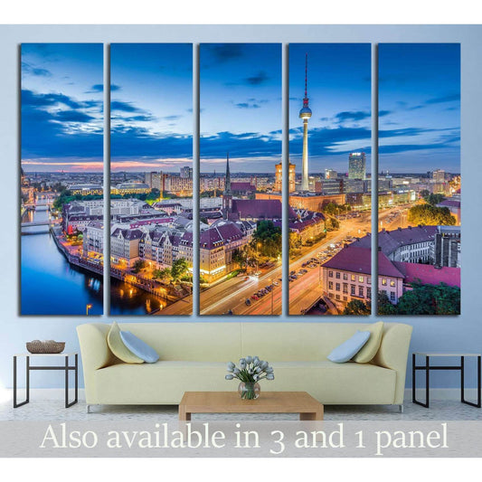 Berlin skyline canvas print with TV Tower at blue hour, displayed above a sofa in a modern living room