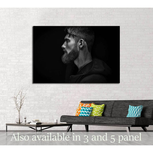 Black and white bearded man profile canvas print hung above sofa in a modern living room