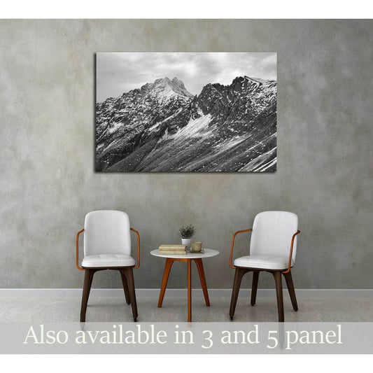 Black and White Rugged Mountains Wall Art for Modern InteriorsThis canvas print presents a striking black and white image of rugged mountain peaks, their sharp contrasts and textures highlighted to create a sense of depth and grandeur. It's a timeless pie
