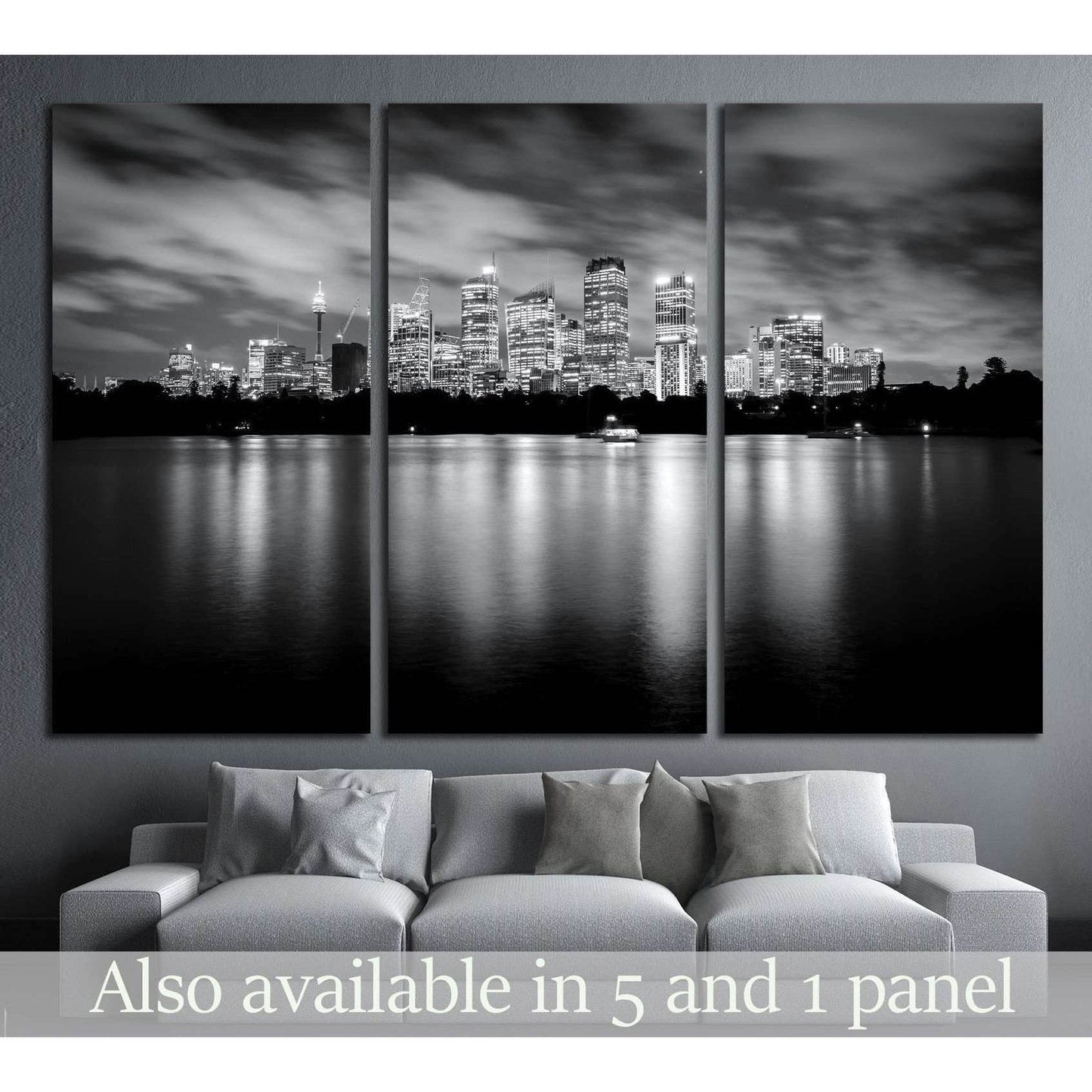 Black and white Sydney skyline triptych canvas print above a sofa with night reflections on the water