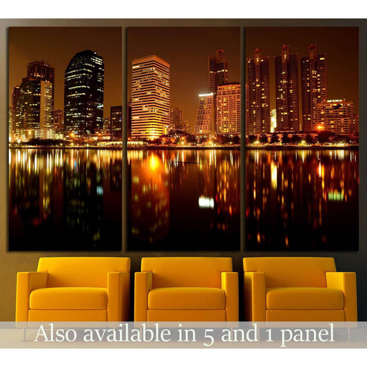 Golden city skyline triptych canvas print with night reflections above mustard chairs