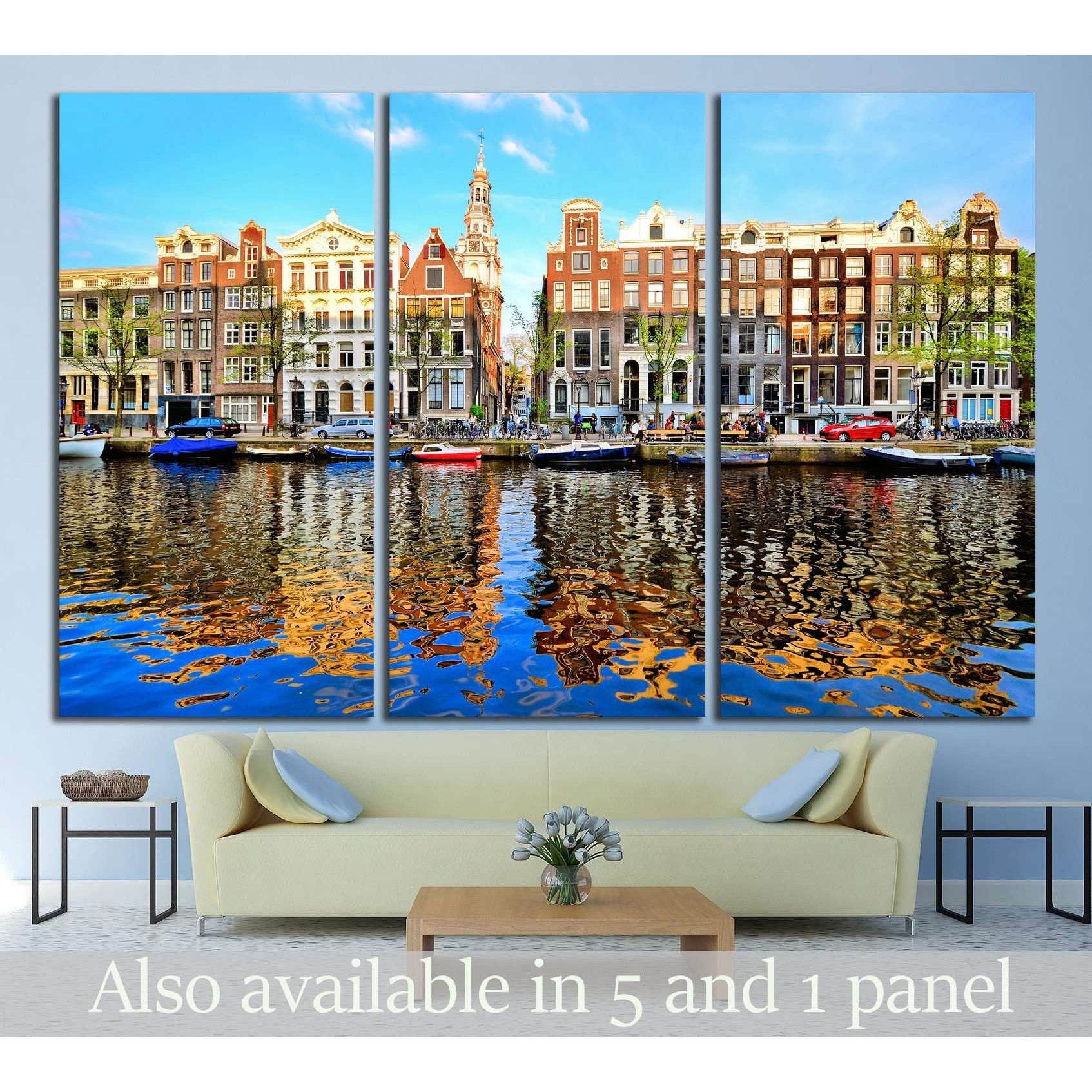 Amsterdam canal houses triptych canvas print with dusk reflections above a sofa in a modern living room