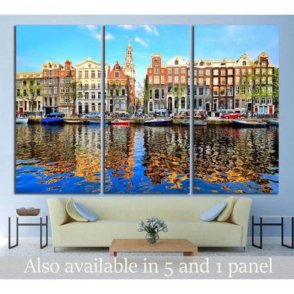 Amsterdam canal houses triptych canvas print with dusk reflections above a sofa in a modern living room