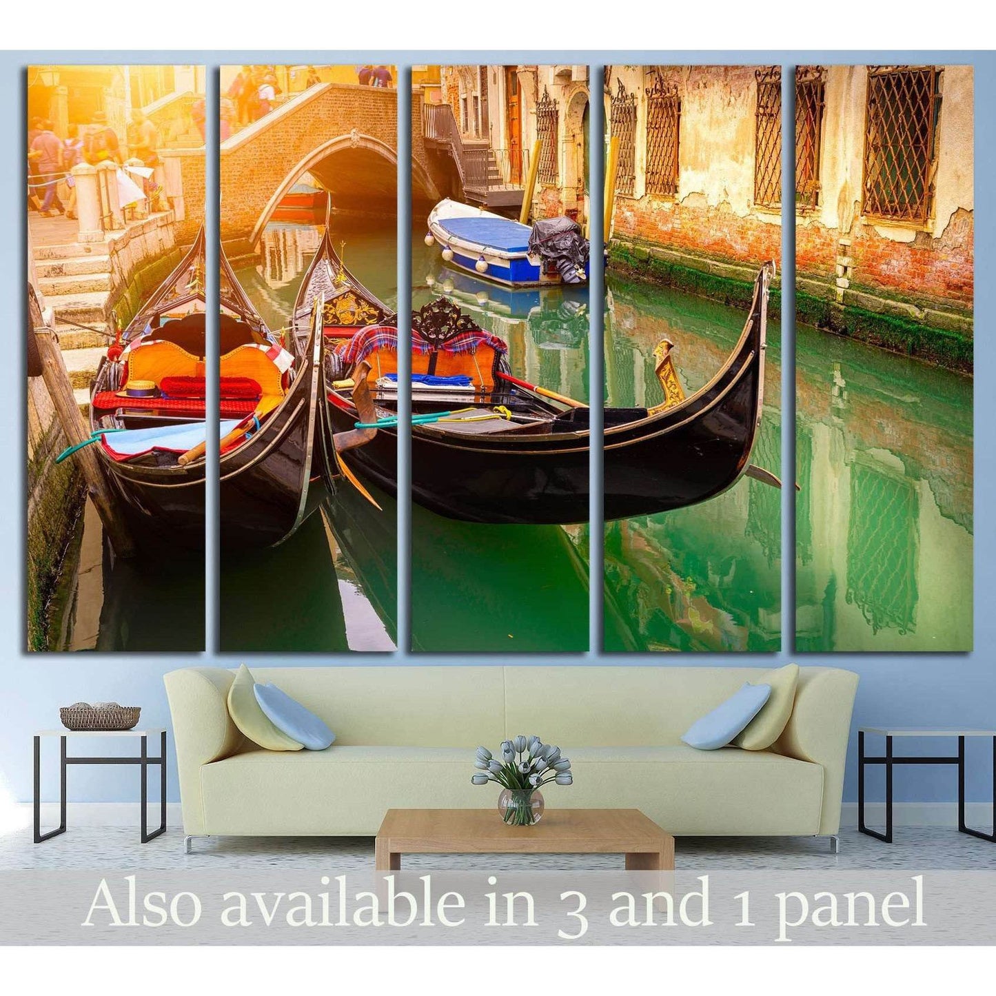 Venice gondola canvas print with two gondolas in green canal water beneath a brick bridge, hung above a sofa