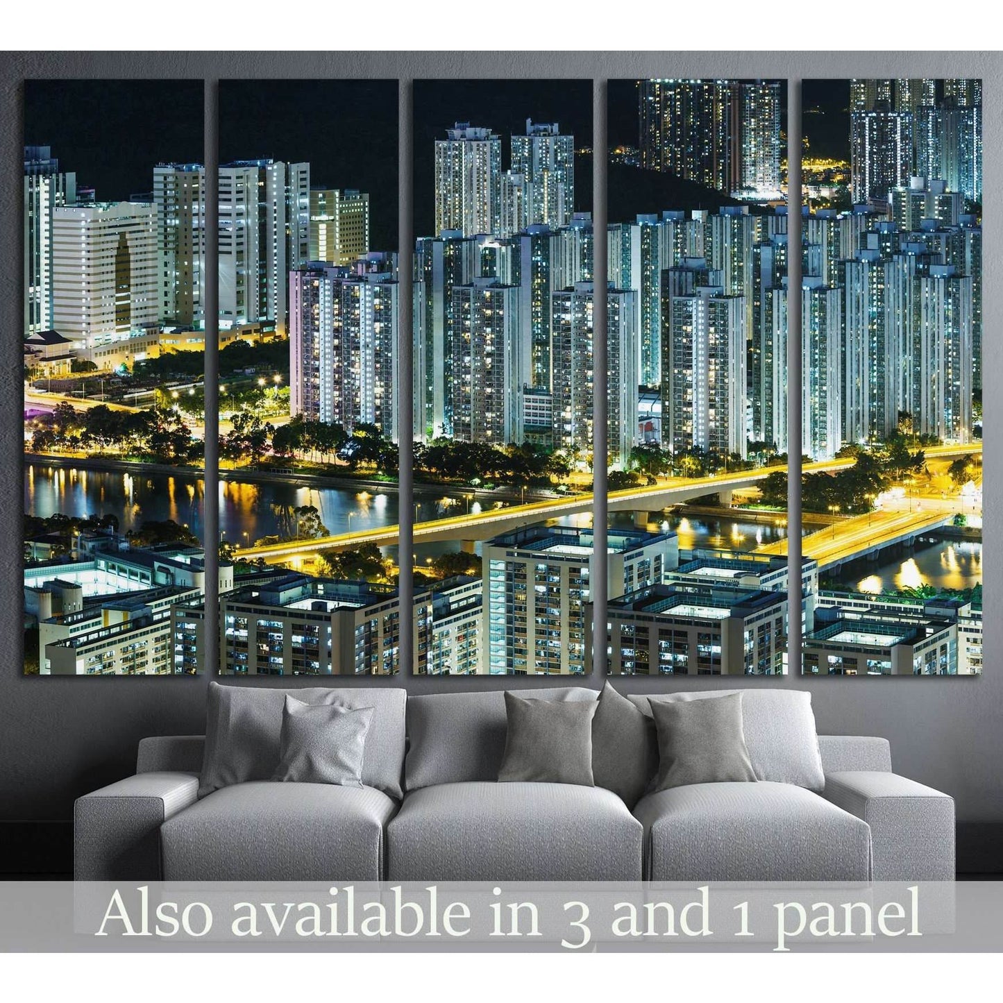 Hong Kong skyline canvas print at night above a gray sofa in a modern living room