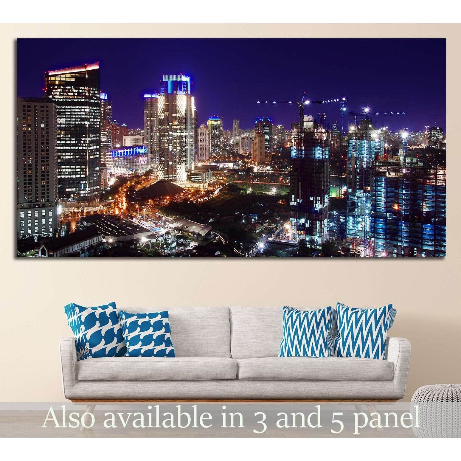 Jakarta skyline canvas print at night with blue and gold city lights above a sofa