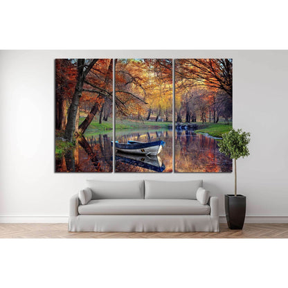 Autumn River Canvas Print for Cozy Living Room WallThis canvas print captures an autumnal scene with a solitary boat on a tranquil river, reflecting the fiery hues of fall foliage. Perfect for adding a touch of natural serenity to any living room or dinin