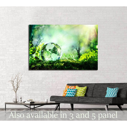 Glass globe resting on moss in a sunlit forest canvas print above a sofa in a modern living room