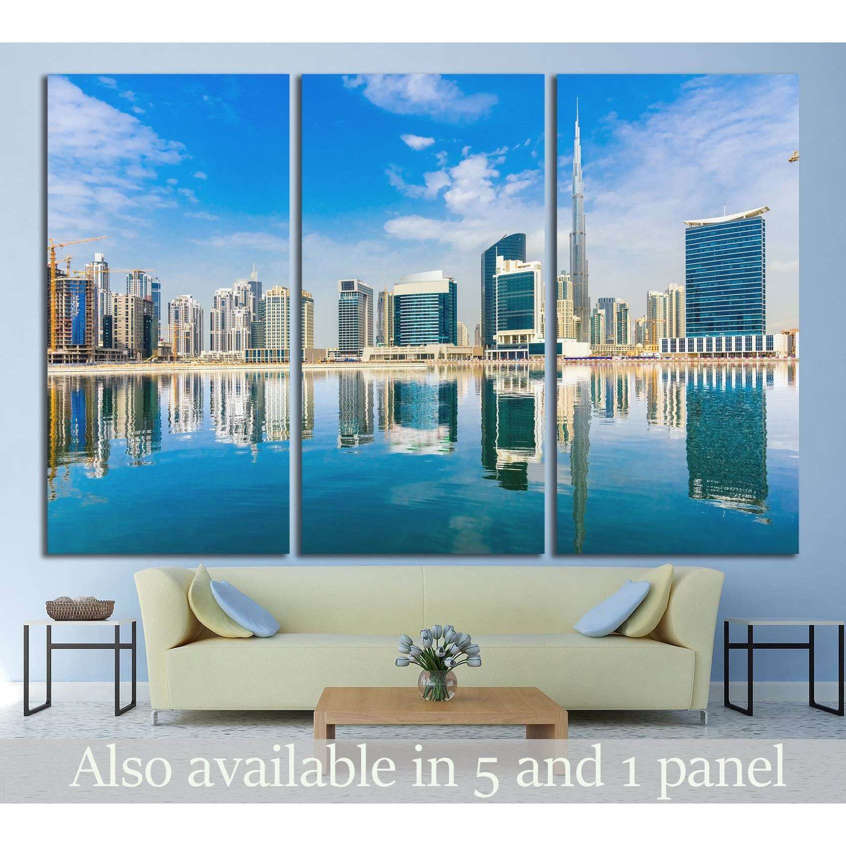 Dubai skyline triptych canvas print with Burj Khalifa and waterfront reflections above a sofa