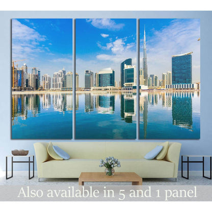 Dubai skyline triptych canvas print with Burj Khalifa and waterfront reflections above a sofa