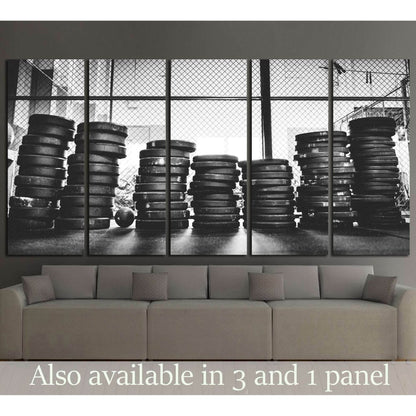 Black and white weight plates canvas print with stacked gym discs in front of industrial windows