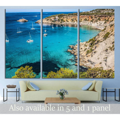 Es Vedra Island Canvas Print - Serene Mediterranean Seascape ArtThis canvas print captures the serene beauty of Es Vedra Island, located off the coast of Ibiza, Spain. The clear, turquoise waters, dotted with leisure boats and framed by rugged cliffs, evo