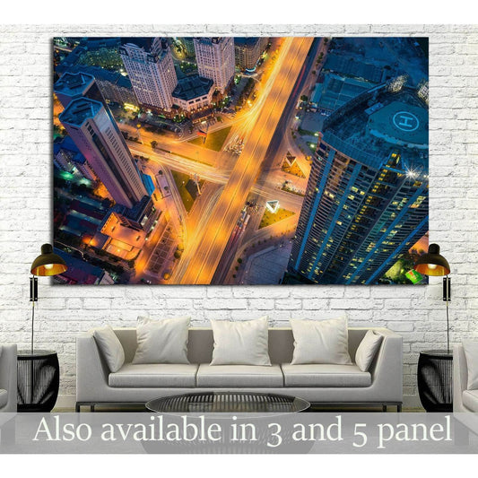 Aerial Hanoi cityscape canvas print with glowing crossroads above a sofa in a modern living room