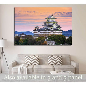 Himeji Castle canvas print above a sofa in a neutral living room with pastel sunset sky