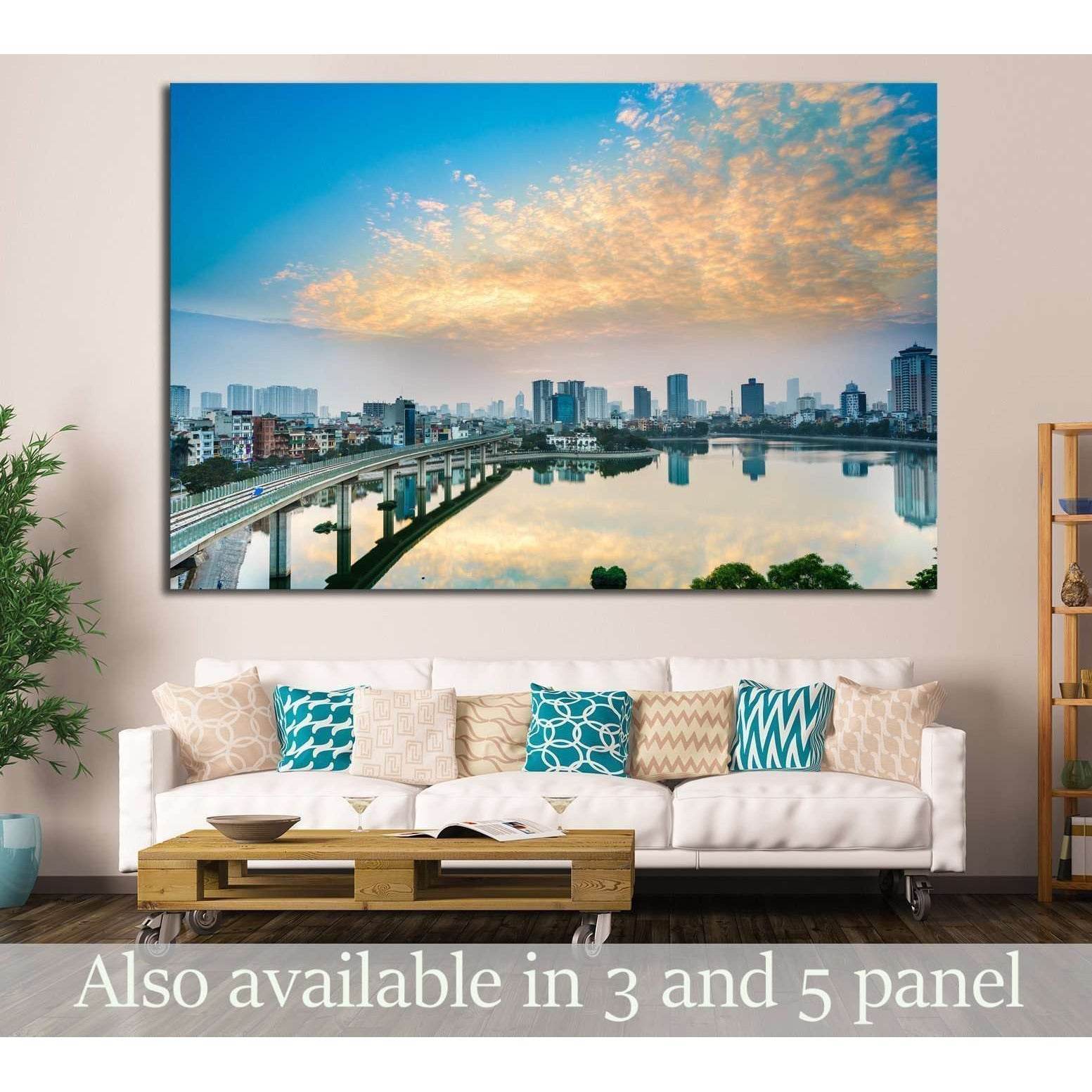 Hanoi cityscape canvas print with Hoang Cau Lake skyline reflection at sunset, hung above a sofa in a modern living room