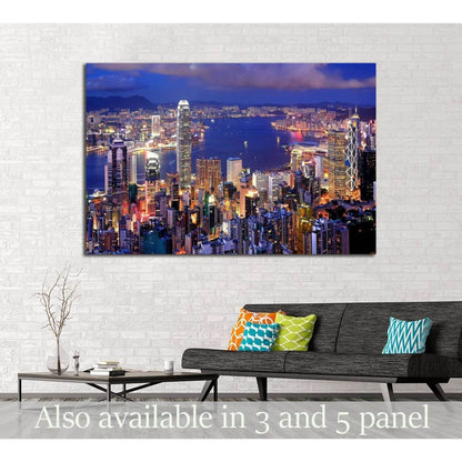 Hong Kong night skyline canvas print above sofa in modern living room with blue harbor lights