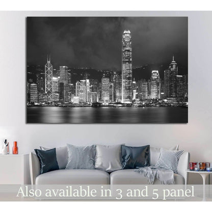 Black and white Hong Kong harbor skyline canvas print above a sofa in a modern living room