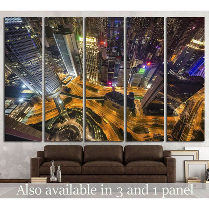 Hong Kong night skyline canvas print with aerial skyscrapers and glowing roads above a sofa