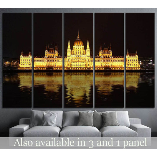 Budapest Parliament canvas print glowing at night above sofa in a modern living room