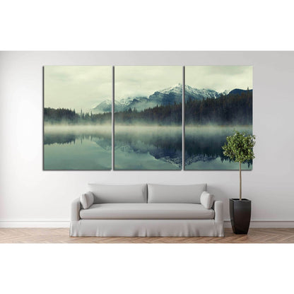 Lake Herbert, Banff National Park, Canada №877 Ready to Hang Canvas PrintThis serene canvas print captures Lake Herbert in Banff National Park, enveloped in mist, with majestic mountains mirrored on the still water. Ideal as wall art, this artwork brings