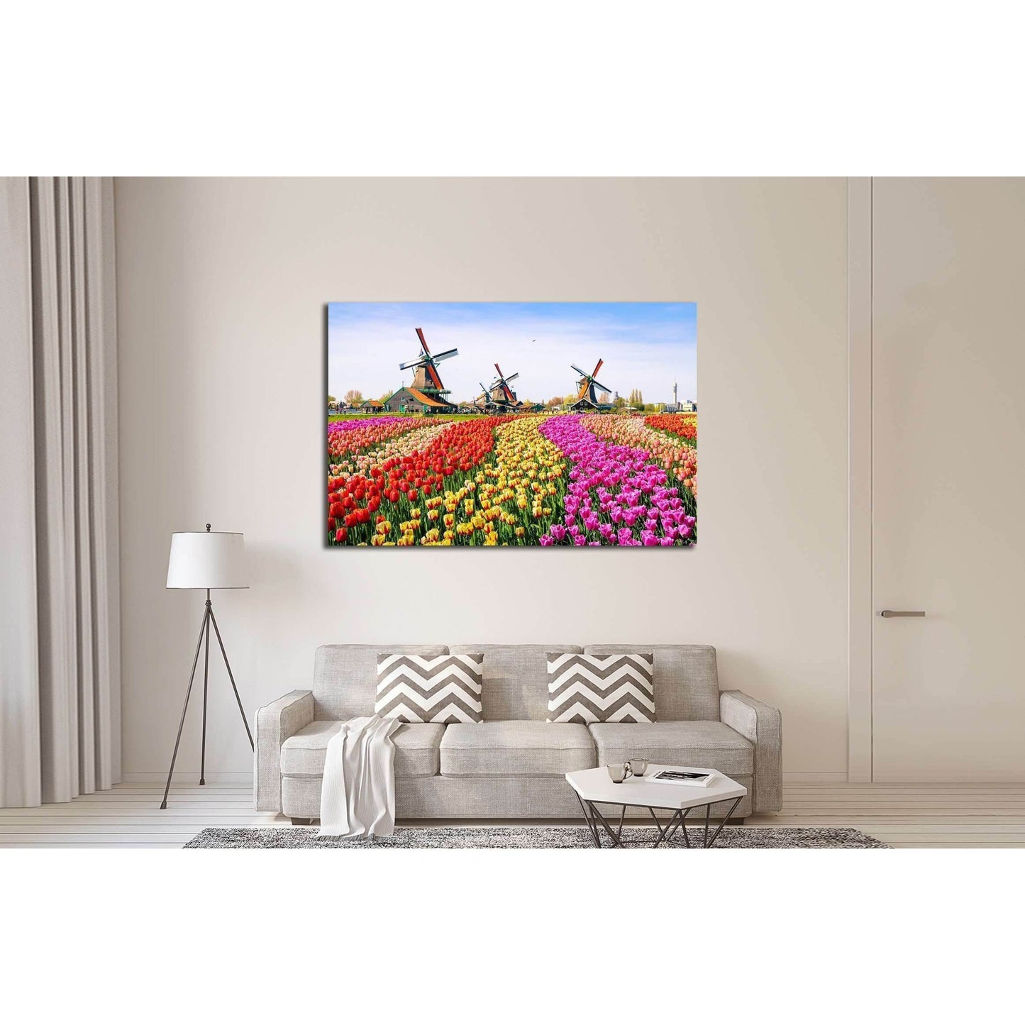 Zaanse Schans Windmills and Tulip Fields Canvas for Vibrant DecorThis canvas print vividly portrays the charming Zaanse Schans with its iconic windmills standing tall above a vibrant field of tulips in the Netherlands. The array of colors and the historic