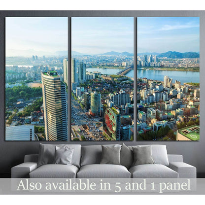 Triptych Seoul skyline canvas print overlooking downtown and the Han River above a gray sofa