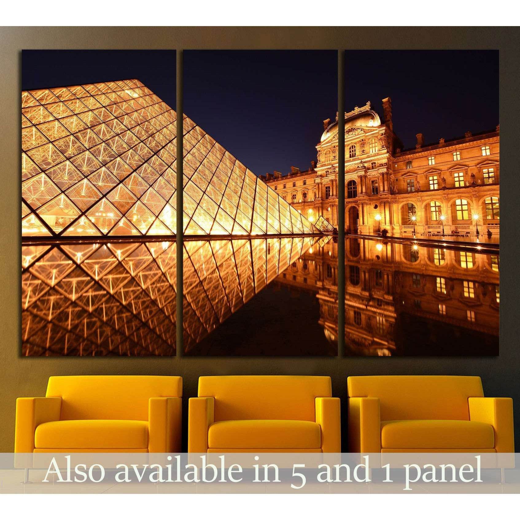 Louvre Pyramid Paris canvas print with golden night reflections, shown as a triptych above yellow chairs