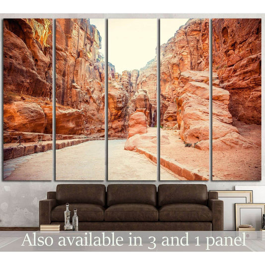 Five-panel ancient city canvas print showing a sunlit sandstone canyon passage above a brown sofa
