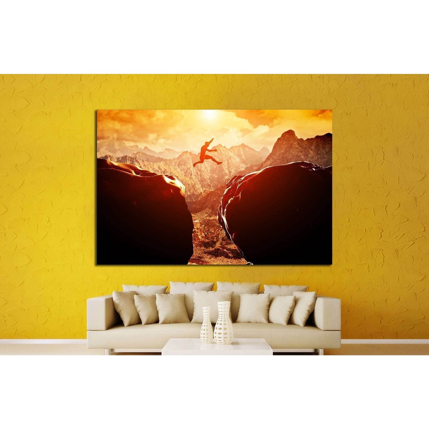 Mountain Base Jump Art Print - Inspirational Extreme Sports Wall ArtThis canvas print depicts an exhilarating scene of a person base jumping between two cliffs with a dramatic mountainous backdrop bathed in the golden hues of the setting or rising sun. It