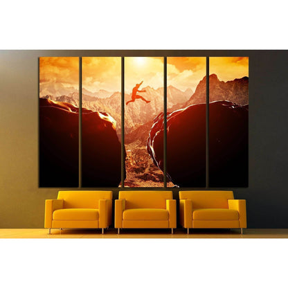Mountain Base Jump Art Print - Inspirational Extreme Sports Wall ArtThis canvas print depicts an exhilarating scene of a person base jumping between two cliffs with a dramatic mountainous backdrop bathed in the golden hues of the setting or rising sun. It