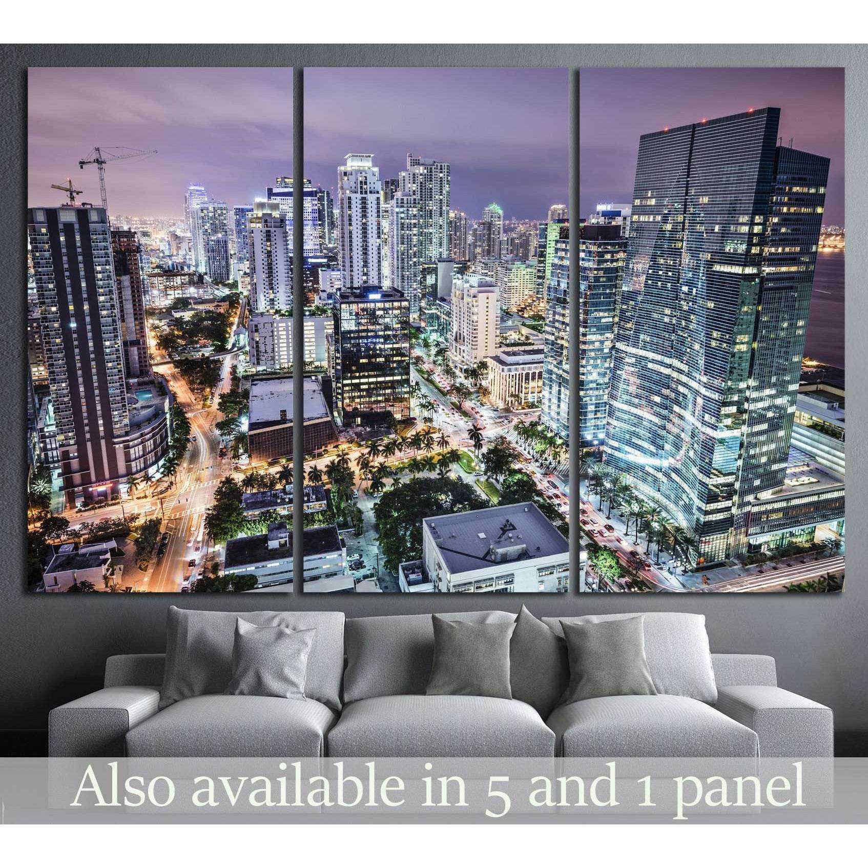 Miami skyline canvas print in a triptych layout above a sofa in a modern living room
