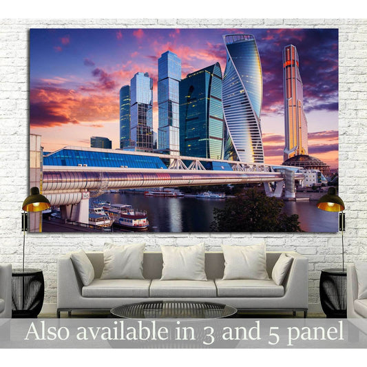Moscow City skyline canvas print with glass skyscrapers at sunset, displayed above a sofa