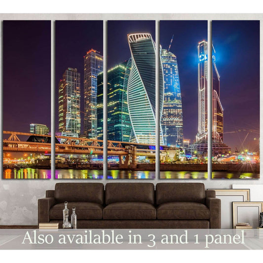 Moscow City skyscrapers at night canvas print above sofa in a modern living room