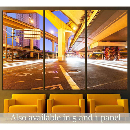 City light trails triptych canvas print with glowing overpasses above yellow chairs