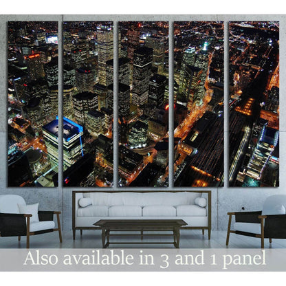 Toronto skyline canvas print with aerial night view of downtown towers above a modern living room sofa