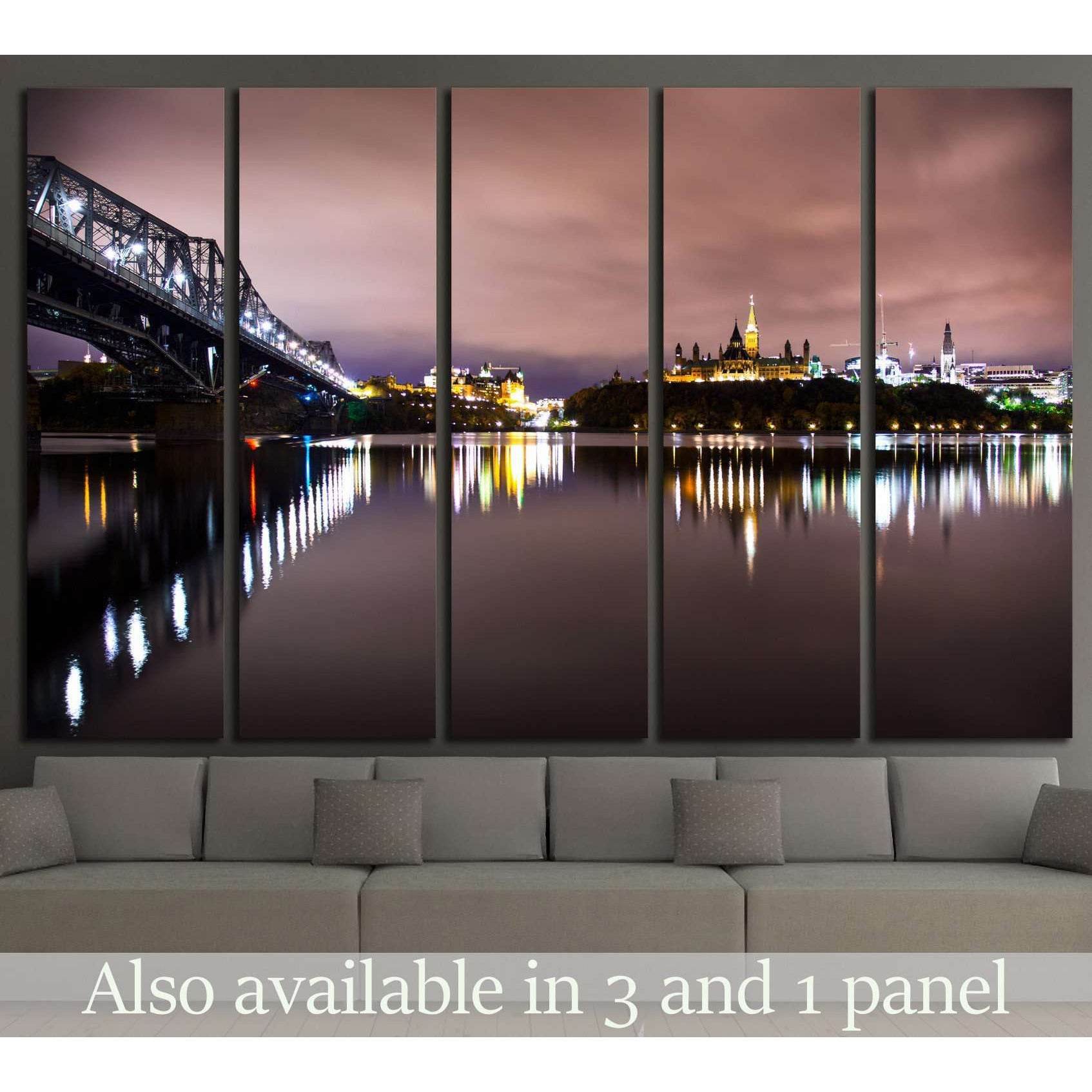 Quebec City skyline canvas print with Alexandra Bridge at night above a sofa in modern living room