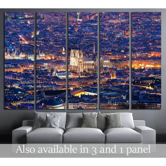 Notre Dame Paris night canvas print in a five-panel cityscape mockup above a gray sofa