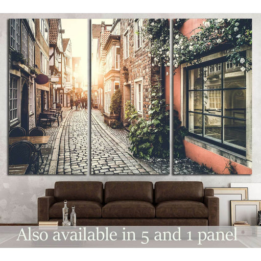 European old town sunset canvas print above sofa with cobblestone street and ivy-covered facades