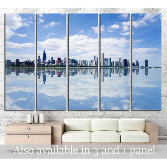 Chicago skyline panoramic canvas print with mirrored waterfront, displayed above a sofa in a modern living room