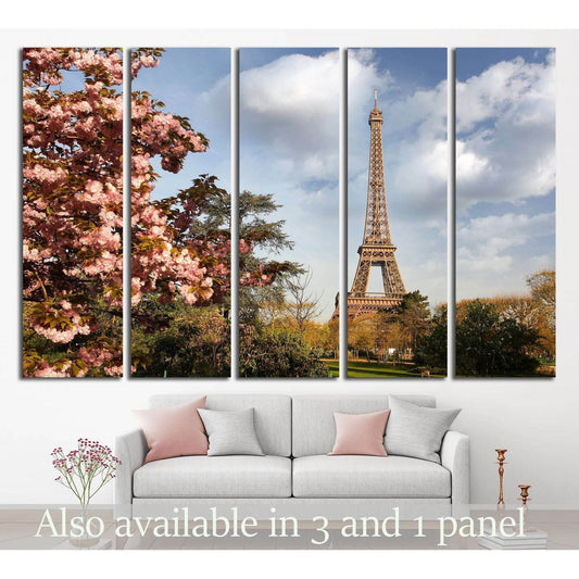 Paris Eiffel Tower canvas print with pink spring blossoms above a sofa in a modern living room