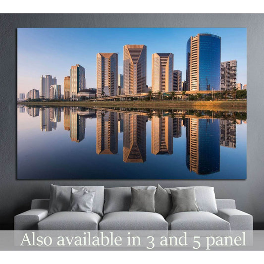 Sao Paulo skyline canvas print with Pinheiros River reflections in warm evening light above a sofa